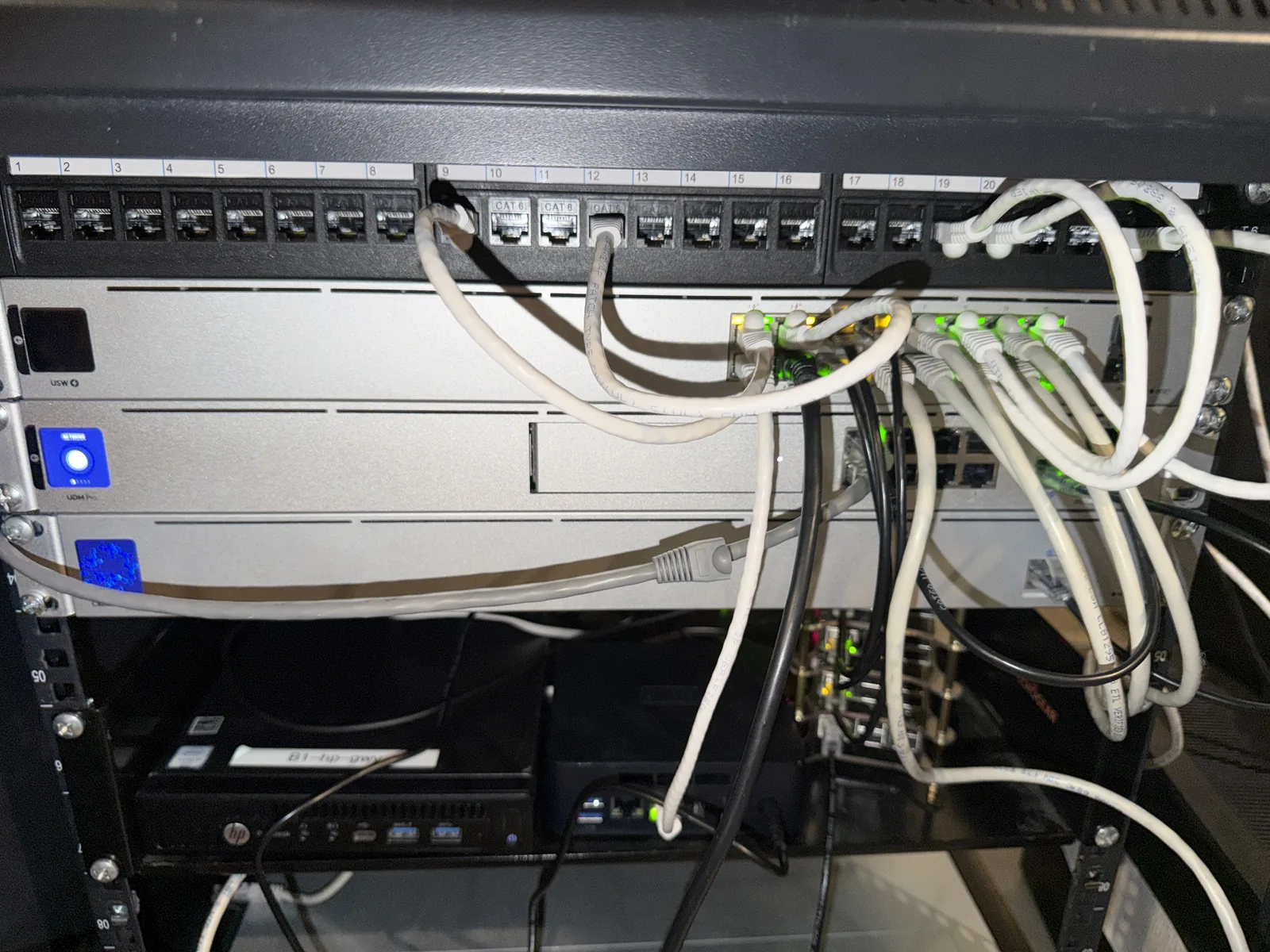 A UniFi UDM Pro and a 16-port PoE switch with cabling